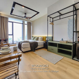 Modern studio apartment interior with minimalist decor, premium king-sized bedding, and clean architectural lines.