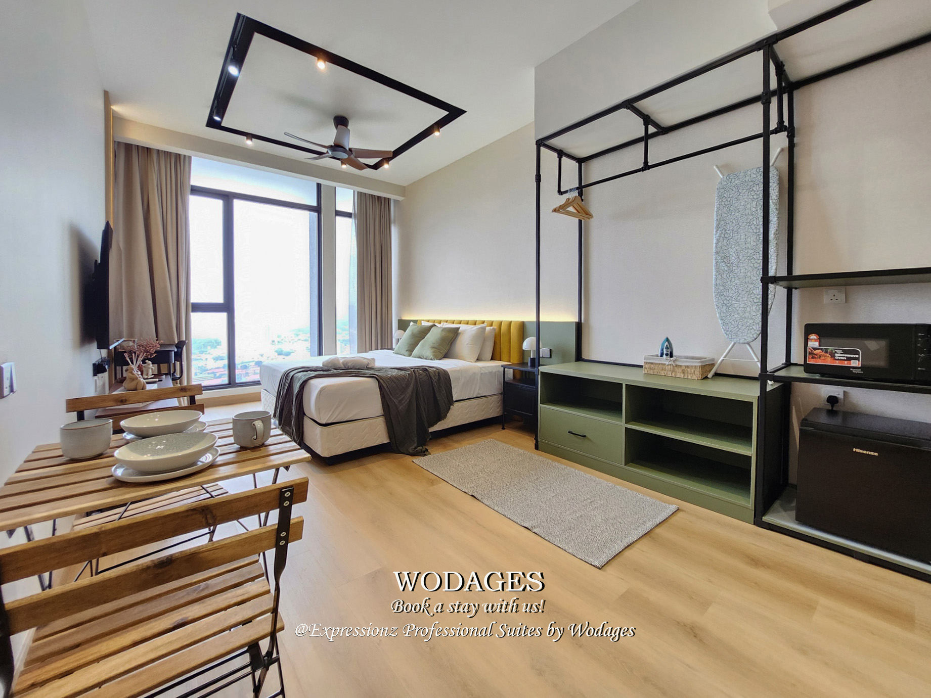 Modern studio apartment interior with minimalist decor, premium king-sized bedding, and clean architectural lines.